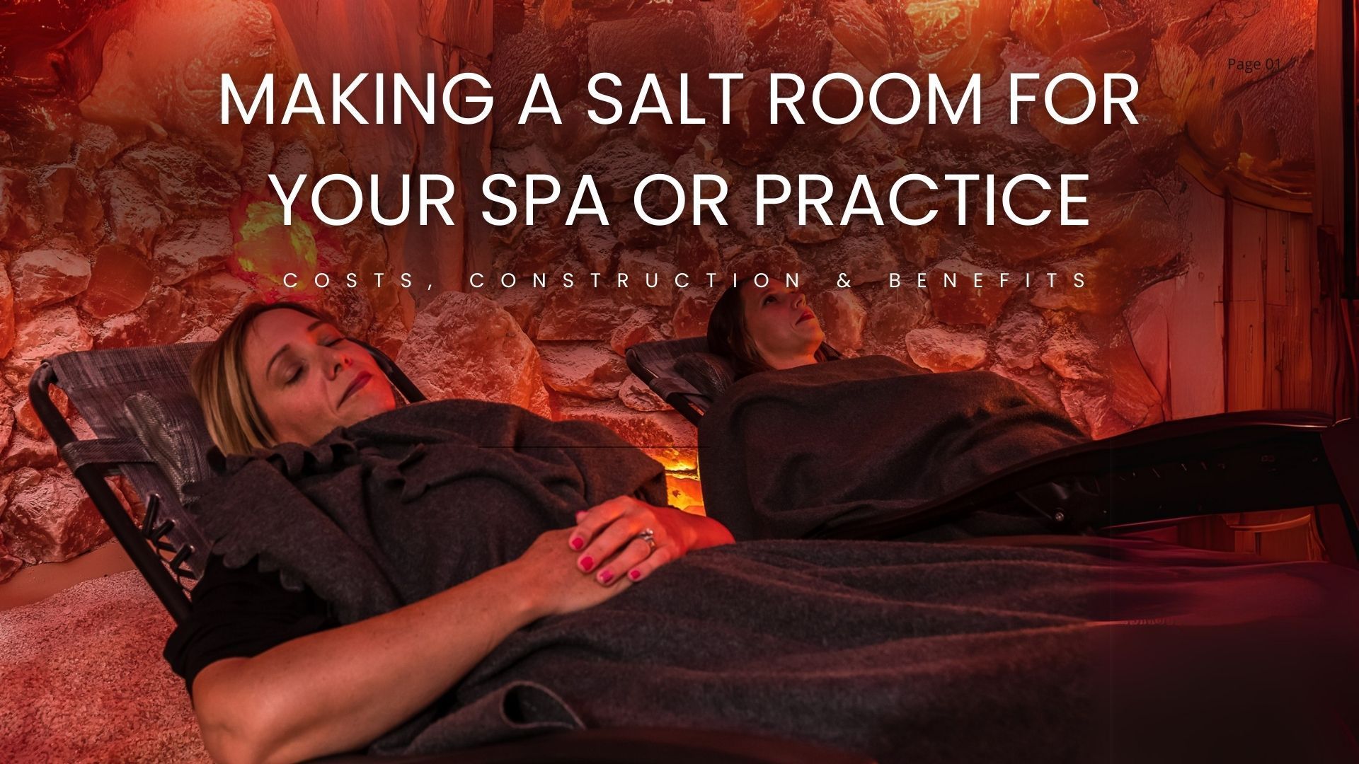 Two people relaxing in a salt room, lit with orange light.