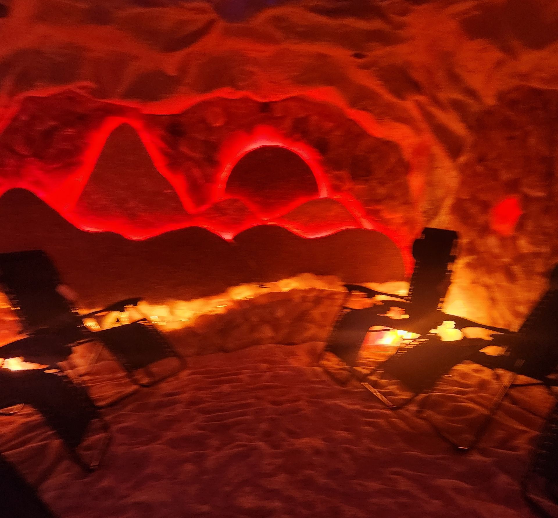 Salt cave with chairs and a red light on the wall