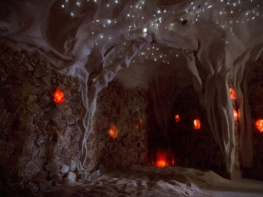 Cave interior with glowing red orbs and a starry ceiling.