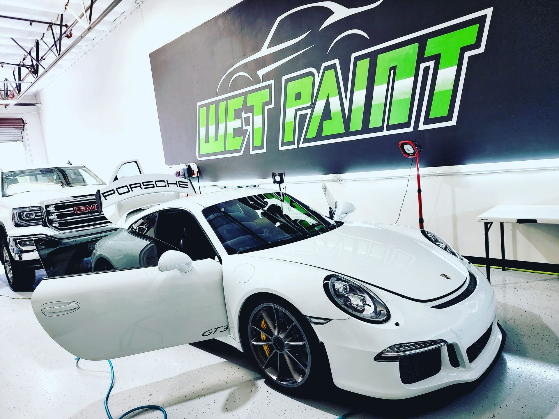 White Porsche GT3 in a shop with 