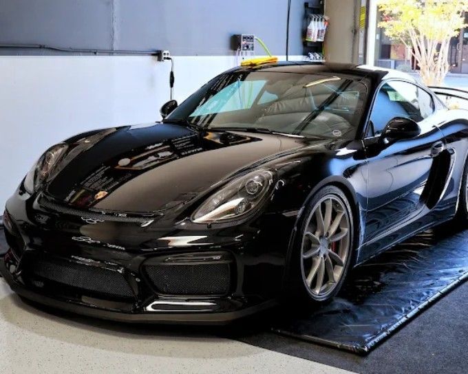 Black Porsche Cayman GT4 getting paint protection film (PPF) applied at Wet Paint Auto Detailing
