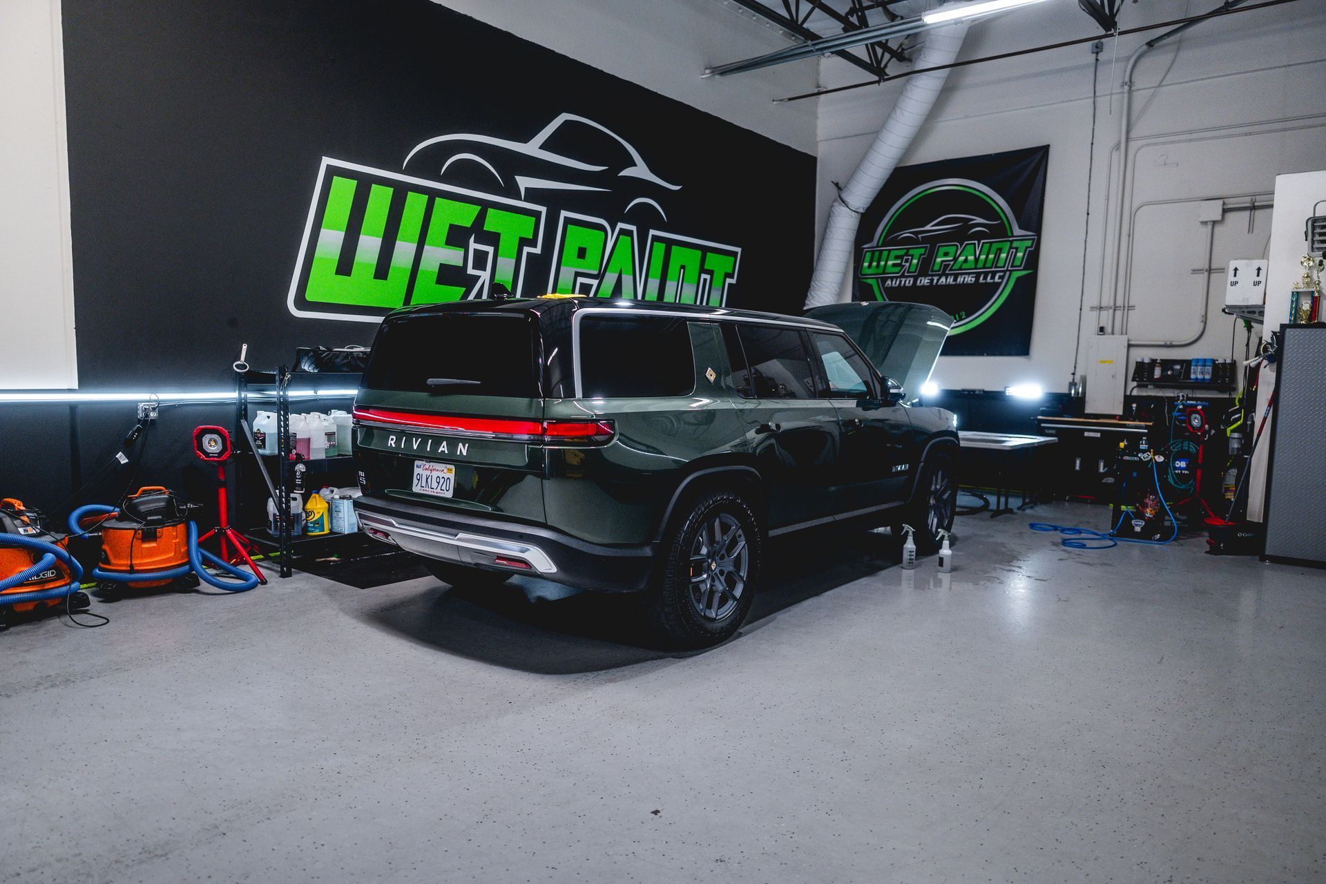 A dark green SUV parked inside a garage with 