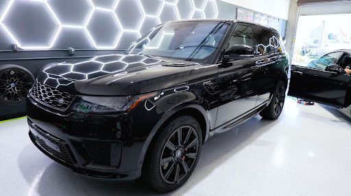 Glossy black Range Rover with ceramic coating under honeycomb studio lighting