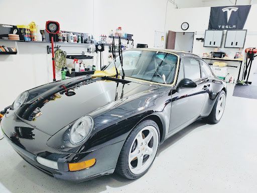 Classic gray Porsche 911 with ceramic coating inside a professional detailing garage