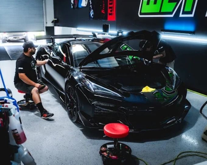 Wet Paint technician applying ceramic coating to a black sports car in Roseville, CA