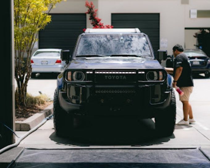 Wet Paint technician washing a black Toyota SUV before ceramic coating in Roseville, CA
