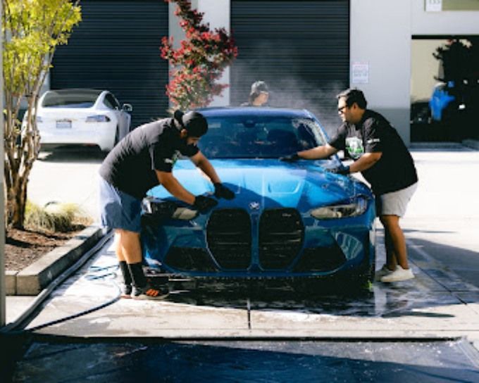 Wet Paint technician prepping a blue BMW for ceramic coating in Roseville, CA