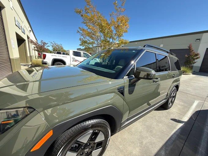Olive green Hyundai Santa Fe parked outside Wet Paint shop after a professional ceramic coating service
