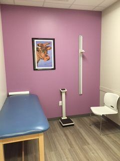 Patient Room with a picture of a giraffe on a purple wall.
