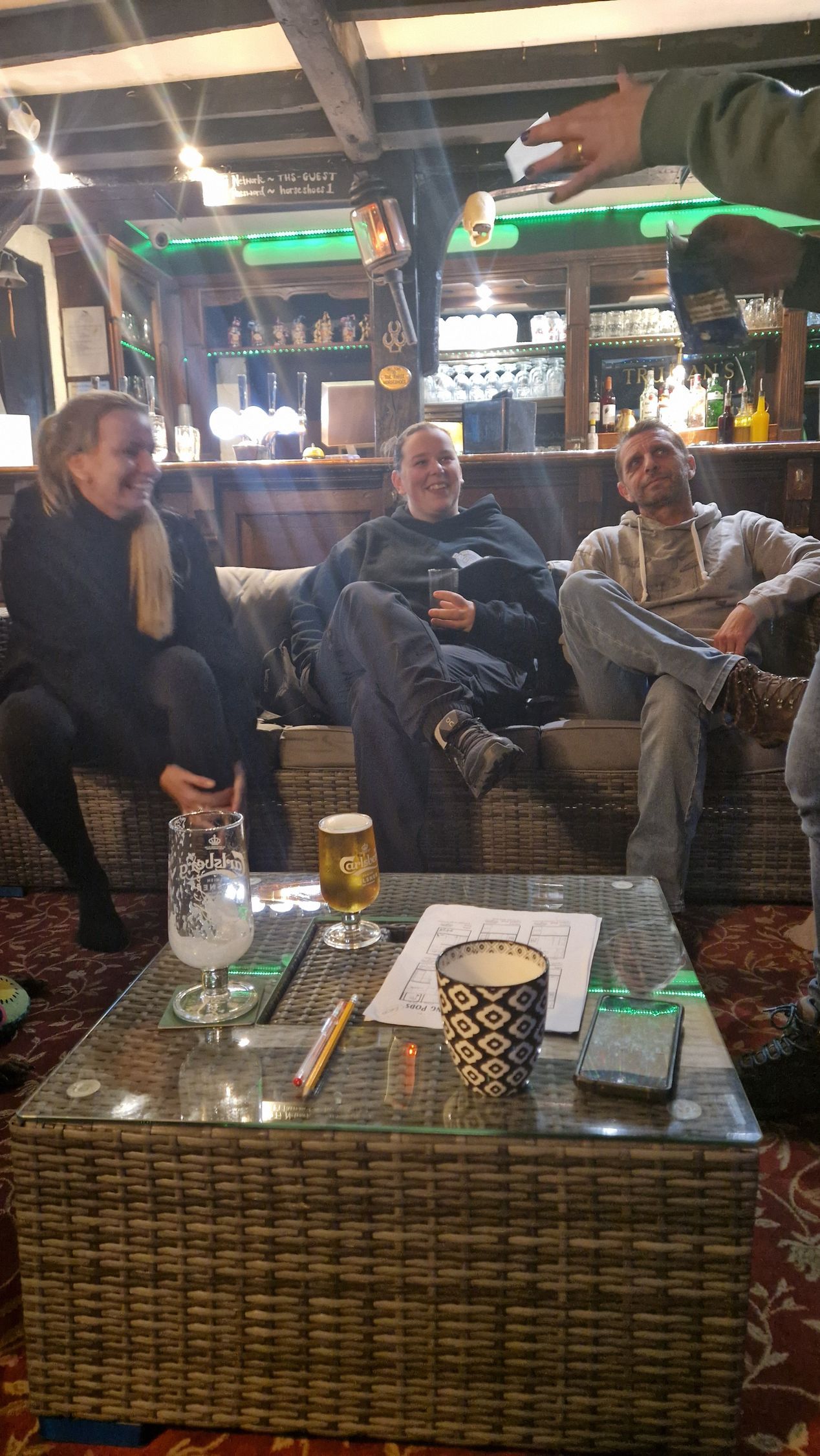 Friends chatting in pub when group booking