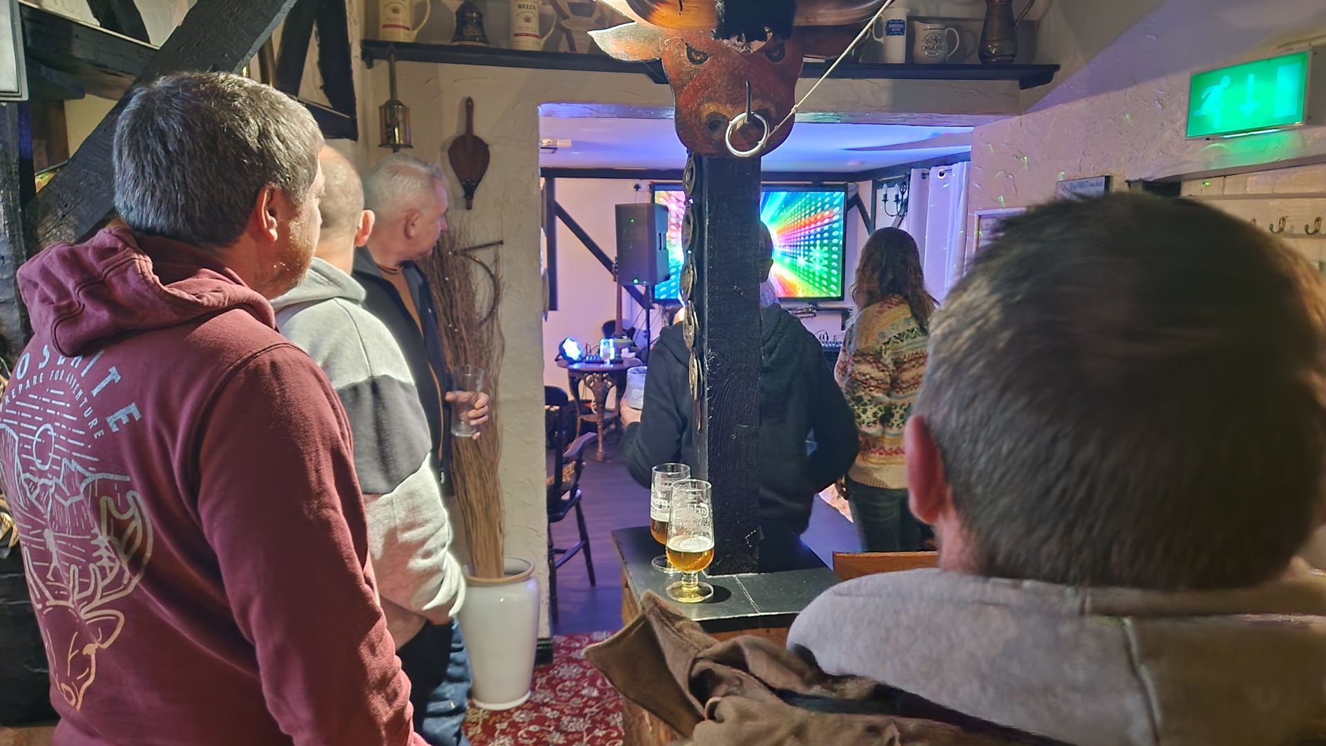 Friends listening to Live music at a Three Horseshoes winter party