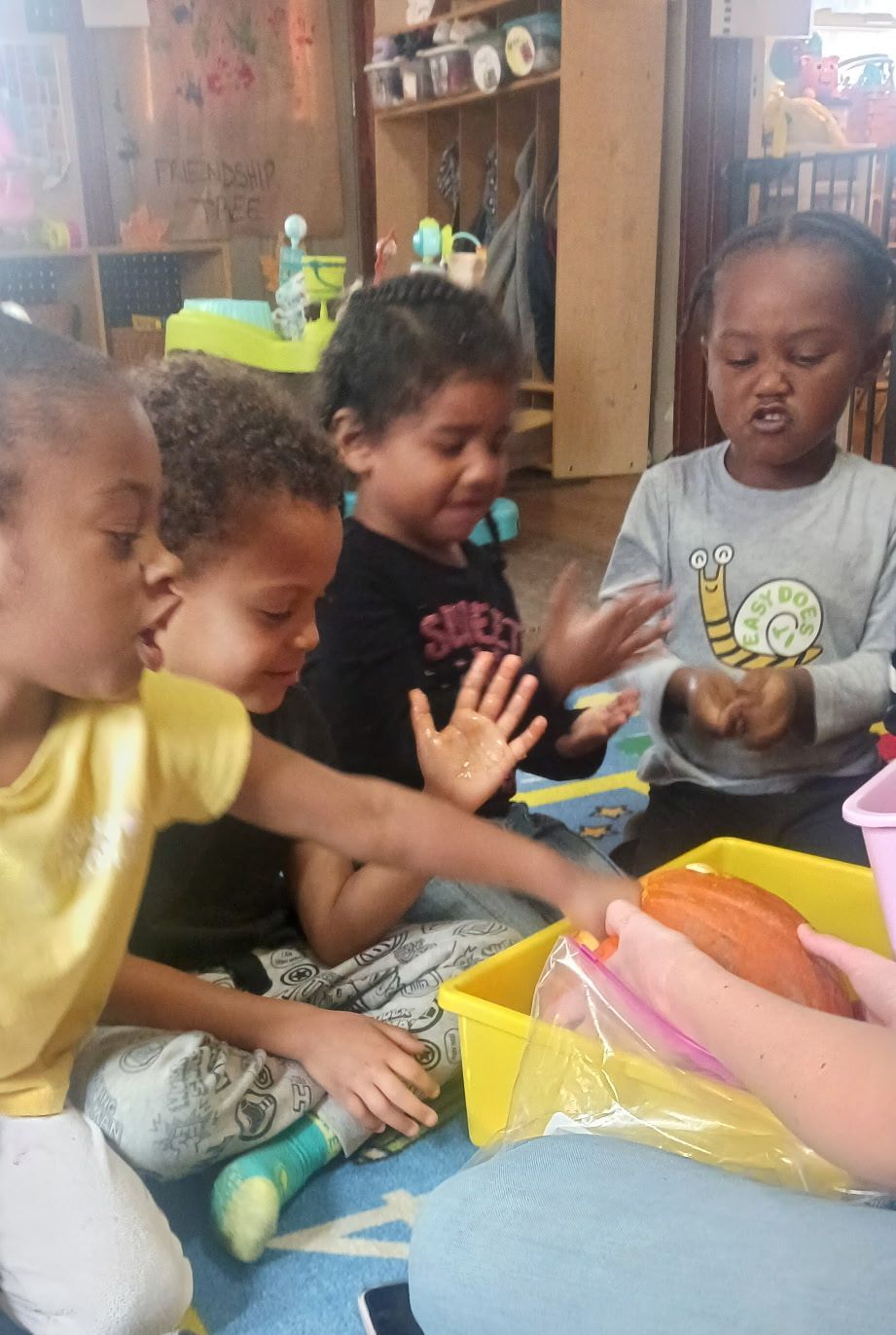 Children playing with colorful toys at a table indoors
