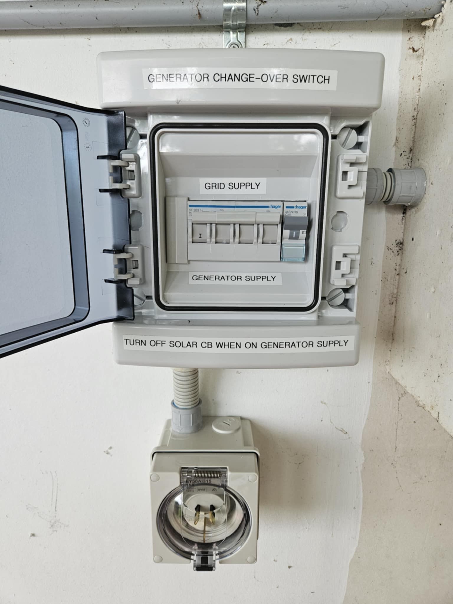Generator Change-over Switch Box And Outdoor Socket On A White Wall With Labels, Conduit, And A Gray Cover — Lit Energy in Seaforth, QLD