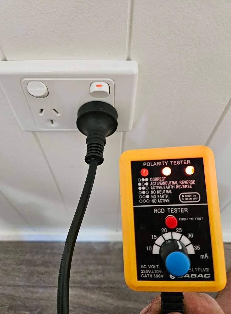 A Polarity Tester Plugged Into An Electrical Outlet, Showing A