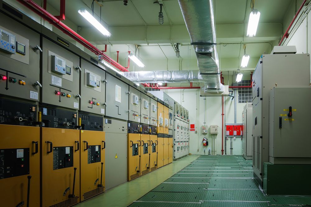 Electrical Control Room With Rows of Panels, Pipes, and Overhead Lights — Lit Energy in Seaforth, QLD
