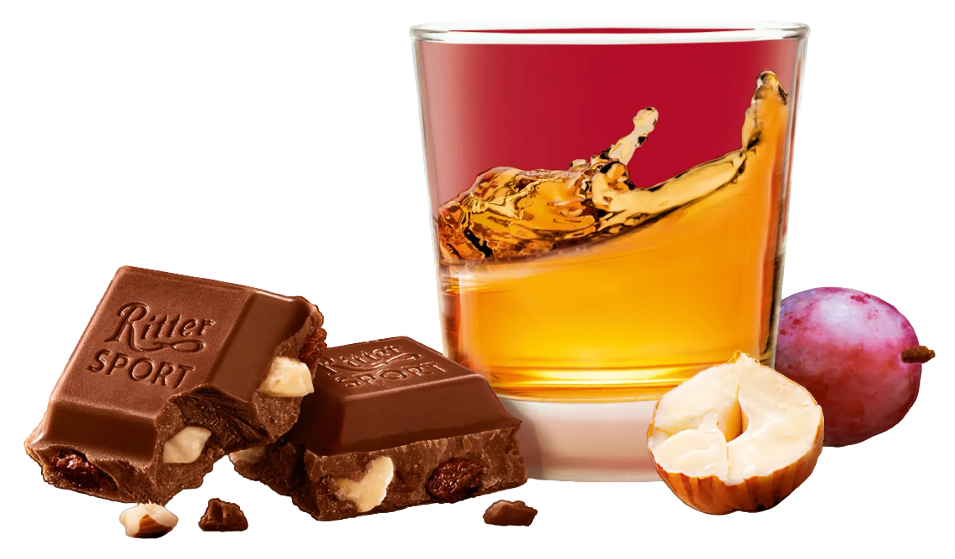 Chocolate bar, hazelnut, grape, and a glass of rum with a splash.