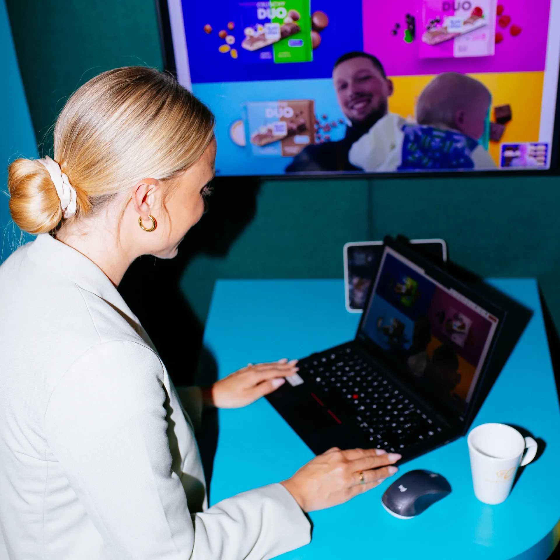 A woman is sitting at a table using a laptop computer