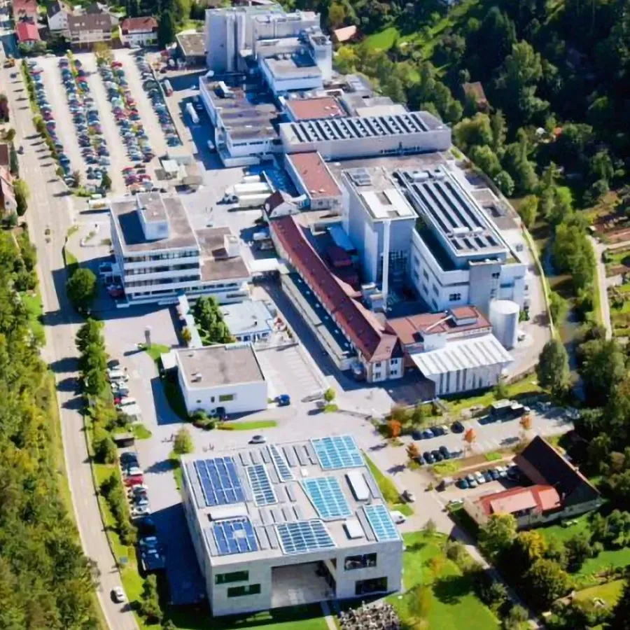An aerial view of a large building with solar panels on the roof