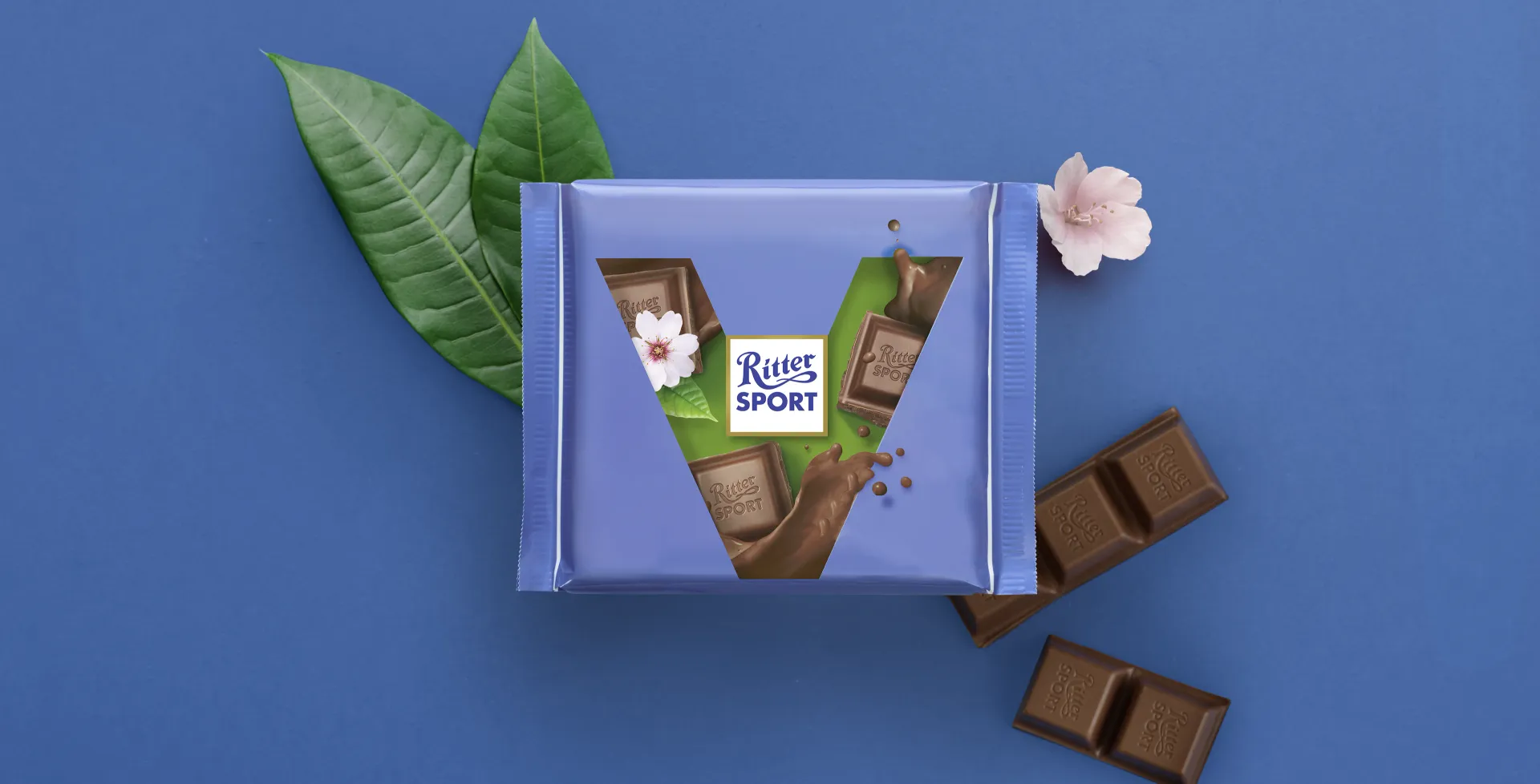 Ritter Sport chocolate bar packaging with cocoa beans, broken chocolate, and milk on a blue background.