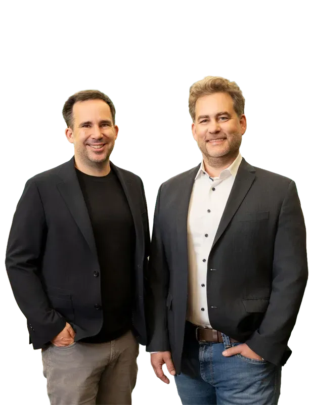 Two brothers smiling and wearing a dark jacket