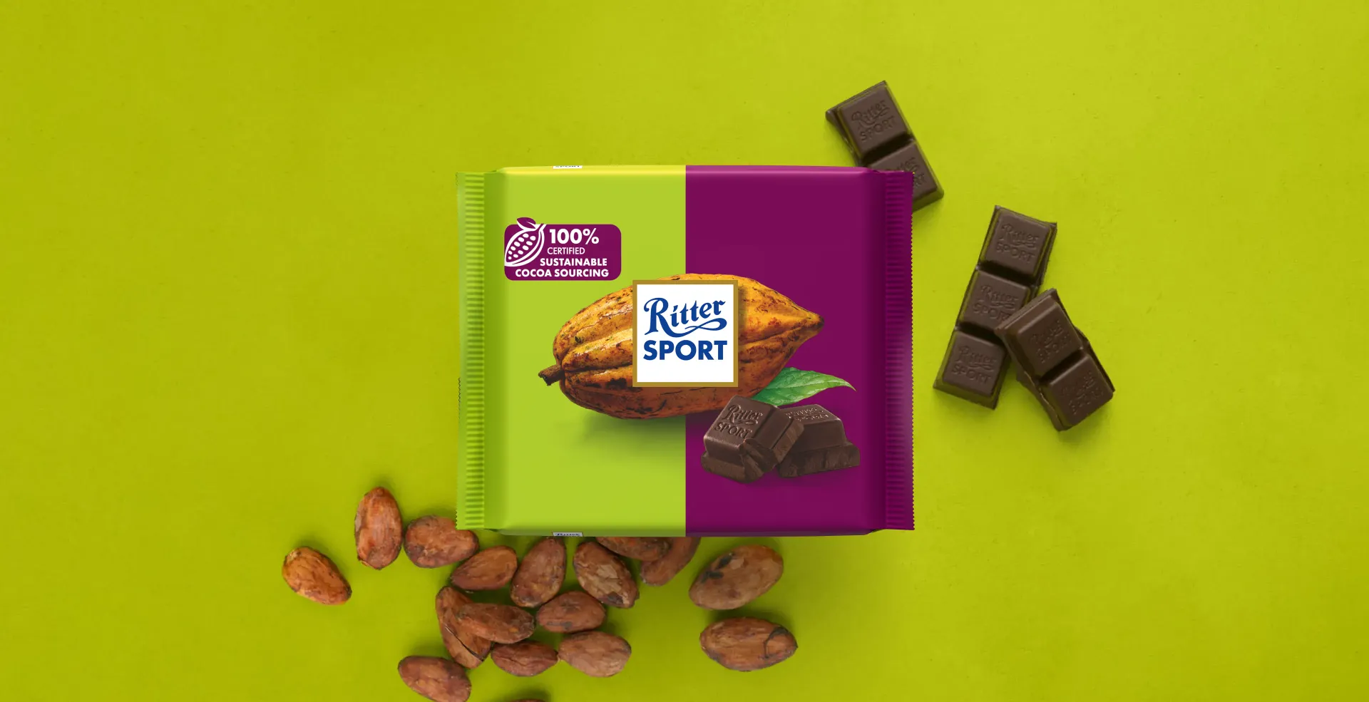 Ritter Sport chocolate bar packaging with cocoa beans, broken chocolate, and milk on a blue background.