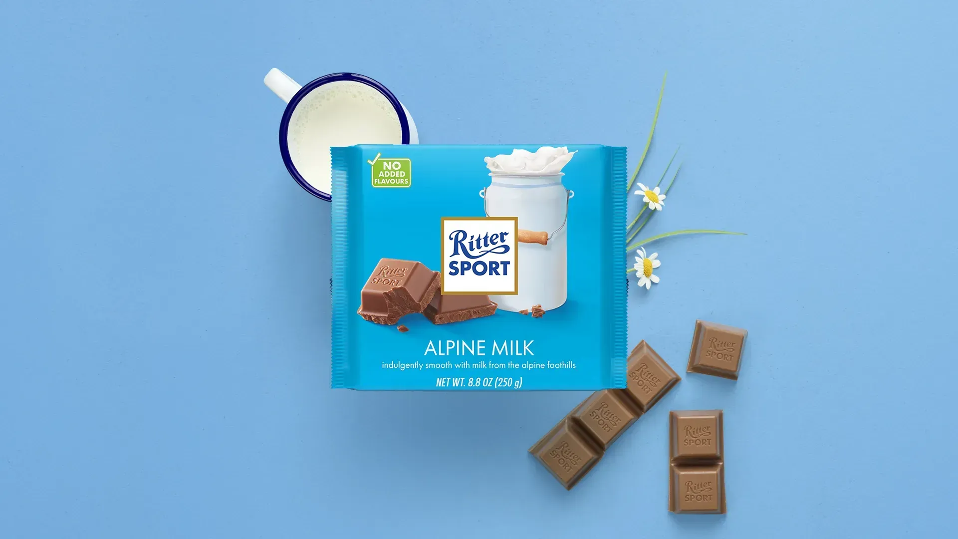 Ritter Sport chocolate bar packaging with cocoa beans, broken chocolate, and milk on a blue background.