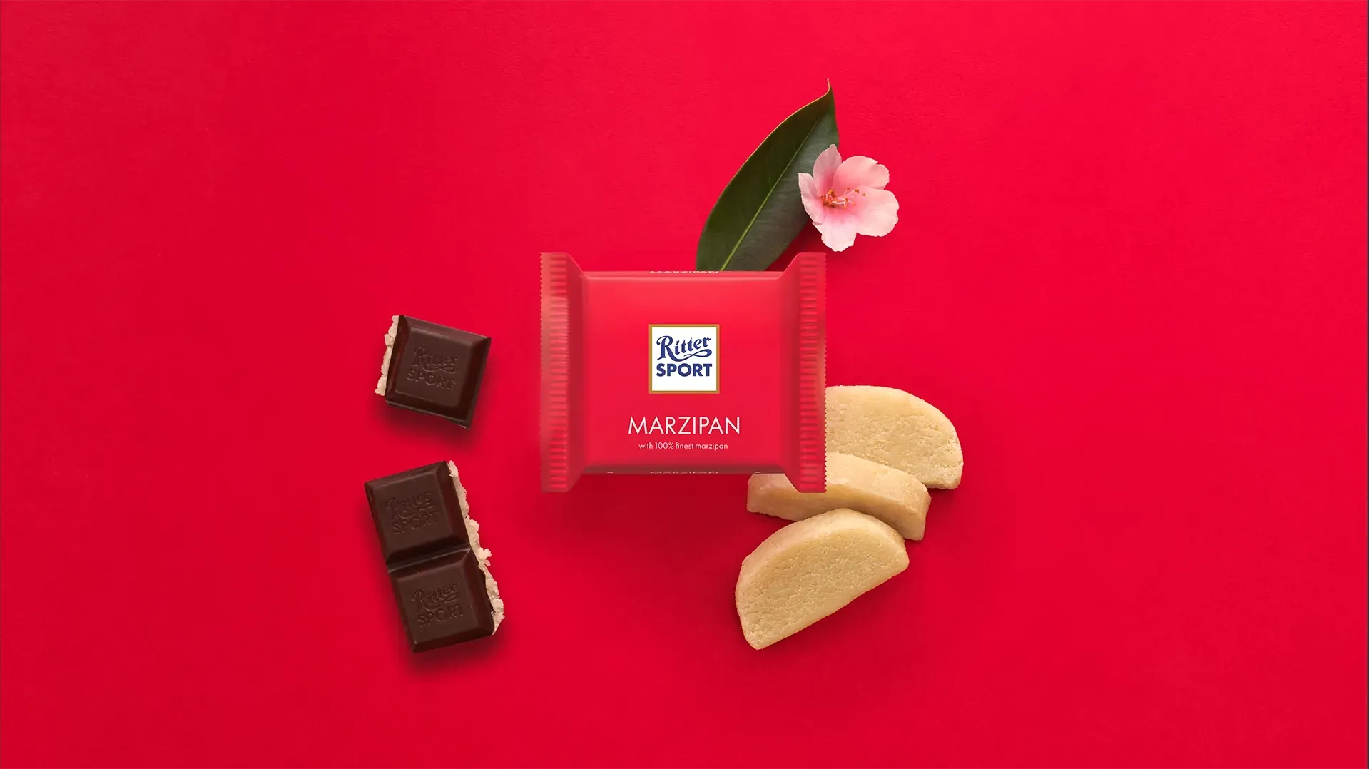 Ritter Sport chocolate bar packaging with cocoa beans, broken chocolate, and milk on a blue background.