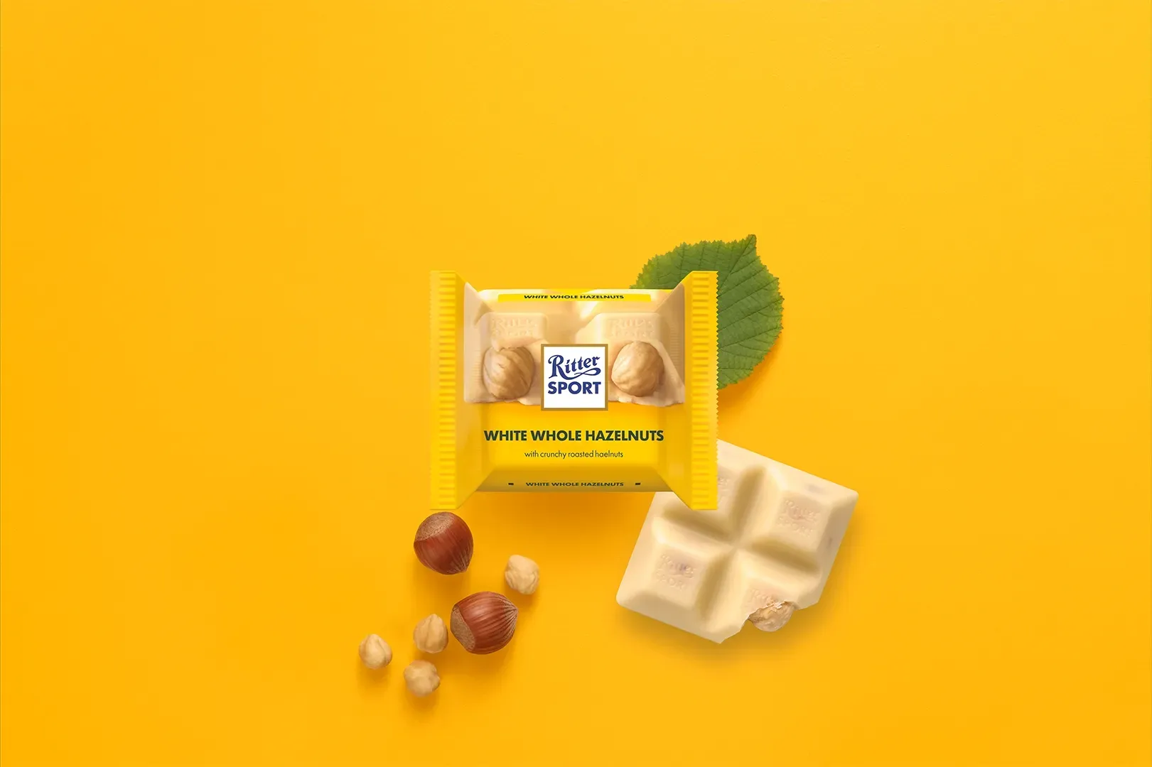 Ritter Sport chocolate bar packaging with cocoa beans, broken chocolate, and milk on a blue background.