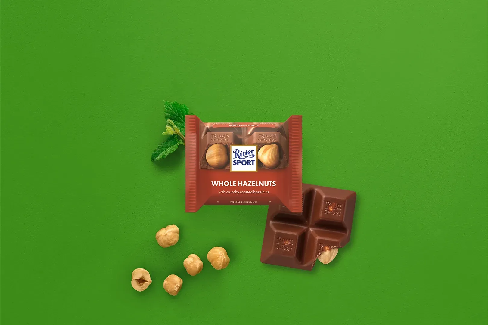 Ritter Sport chocolate bar packaging with cocoa beans, broken chocolate, and milk on a blue background.