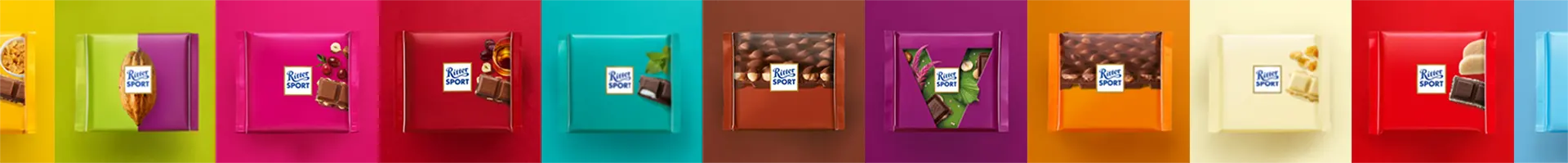 A row of colorful chocolates are lined up in a row.