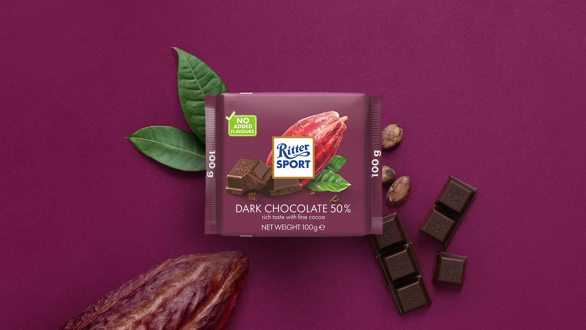 Ritter Sport chocolate bar packaging with cocoa beans, broken chocolate, and milk on a blue background.