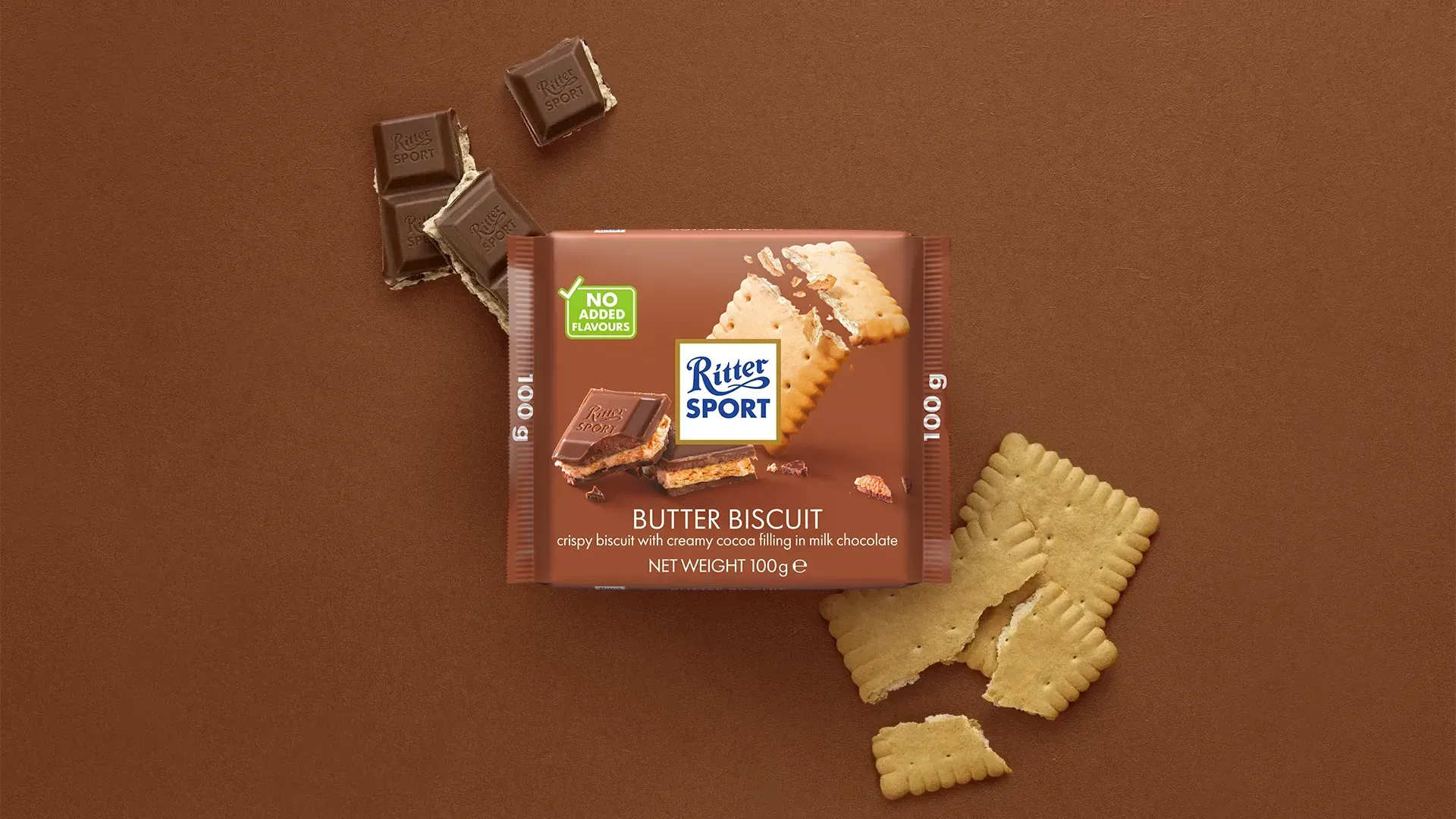 Ritter Sport chocolate bar packaging with cocoa beans, broken chocolate, and milk on a blue background.