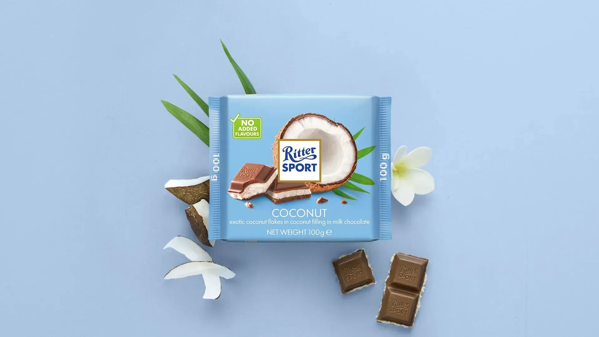 Ritter Sport chocolate bar packaging with cocoa beans, broken chocolate, and milk on a blue background.