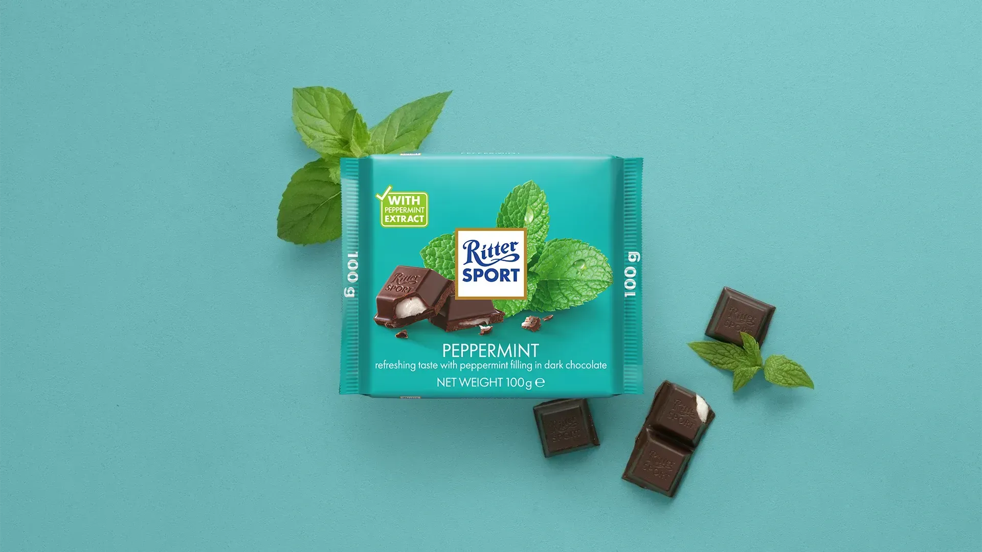Ritter Sport chocolate bar packaging with cocoa beans, broken chocolate, and milk on a blue background.
