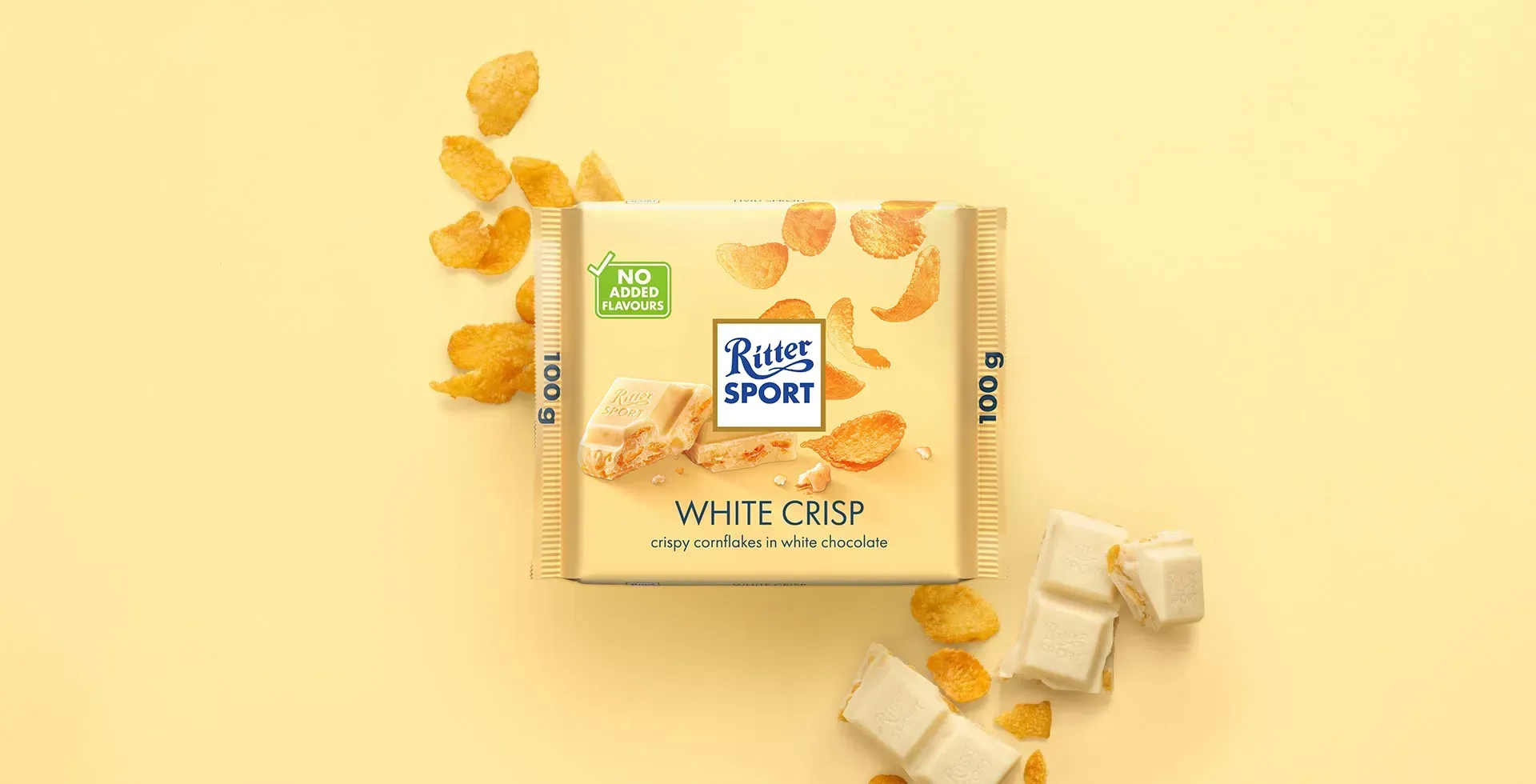 Ritter Sport chocolate bar packaging with cocoa beans, broken chocolate, and milk on a blue background.