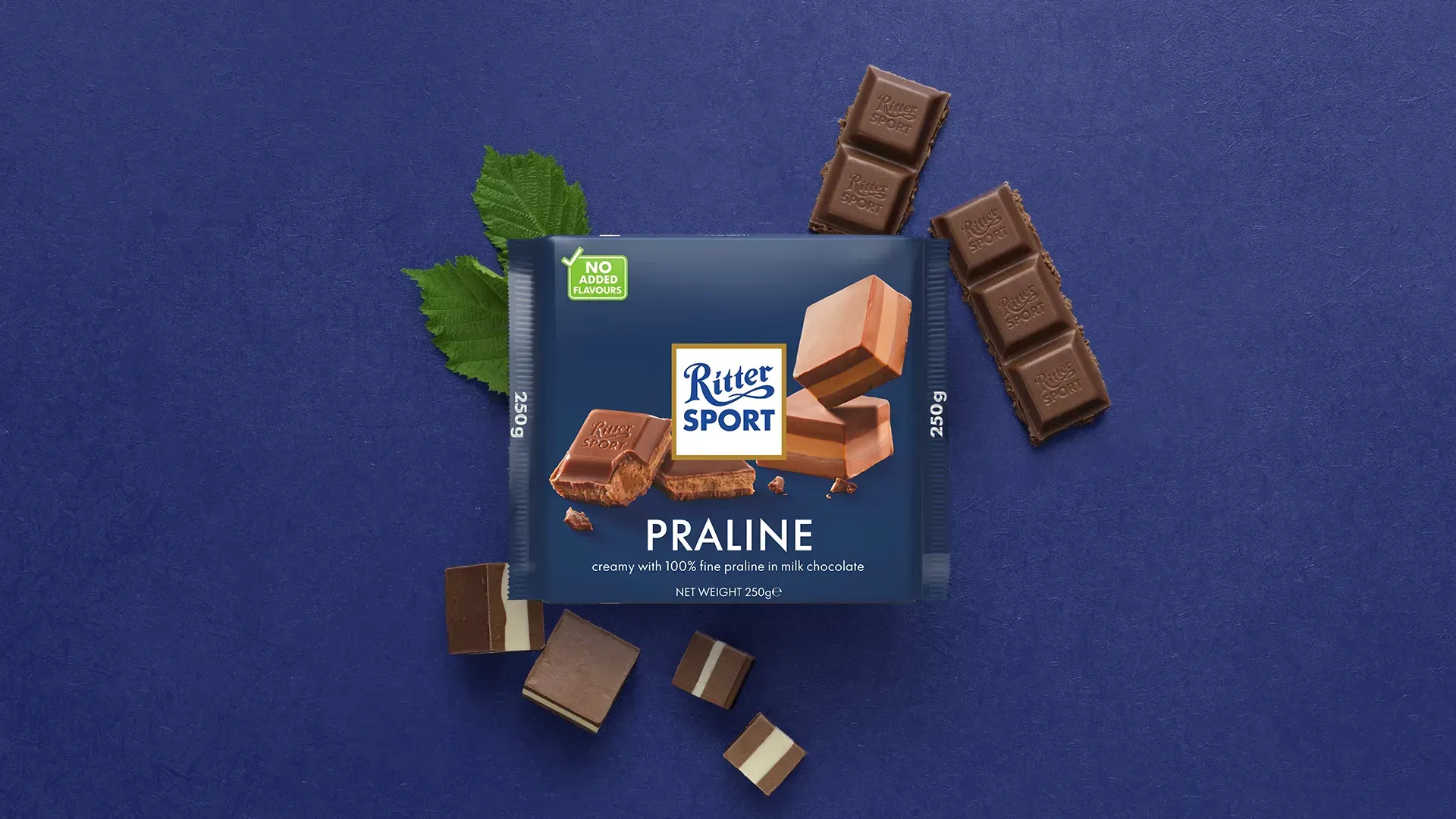 Ritter Sport chocolate bar packaging with cocoa beans, broken chocolate, and milk on a blue background.