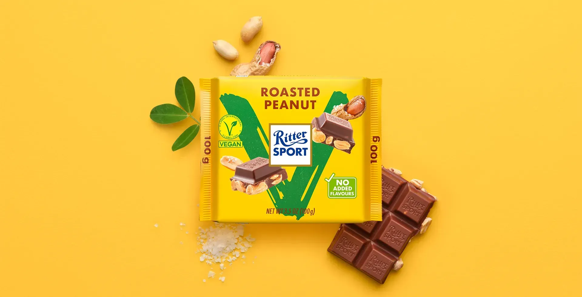 Ritter Sport chocolate bar packaging with cocoa beans, broken chocolate, and milk on a blue background.