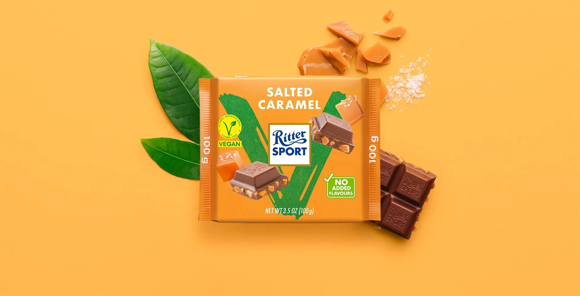 Ritter Sport chocolate bar packaging with cocoa beans, broken chocolate, and milk on a blue background.