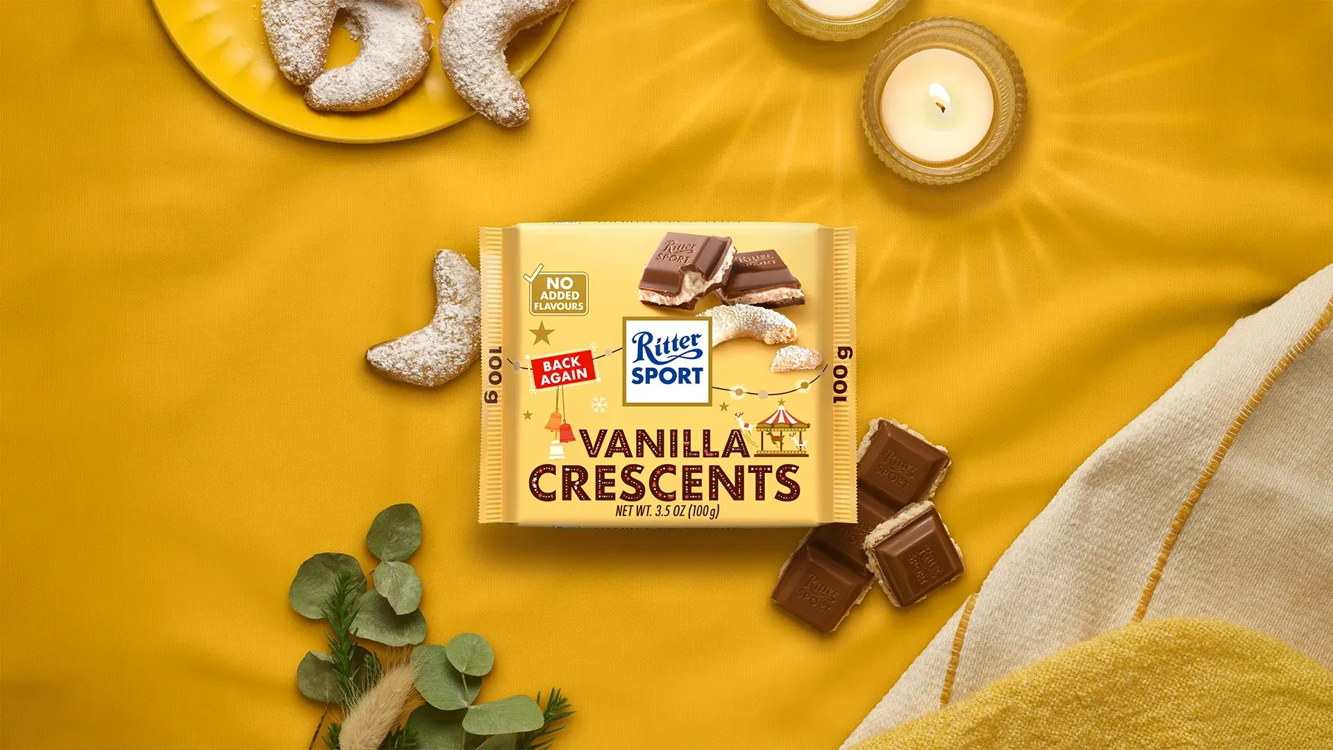 Ritter Sport chocolate bar packaging with cocoa beans, broken chocolate, and milk on a blue background.