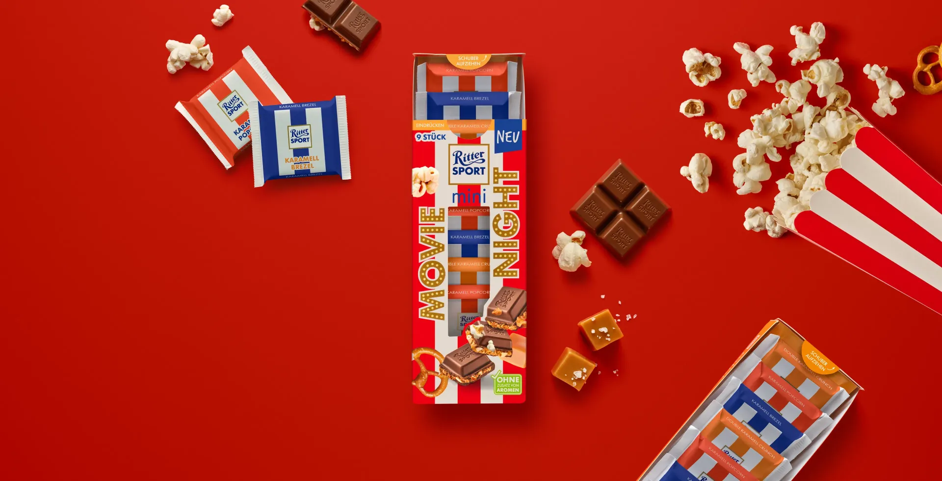 Ritter Sport chocolate bar packaging with cocoa beans, broken chocolate, and milk on a blue background.