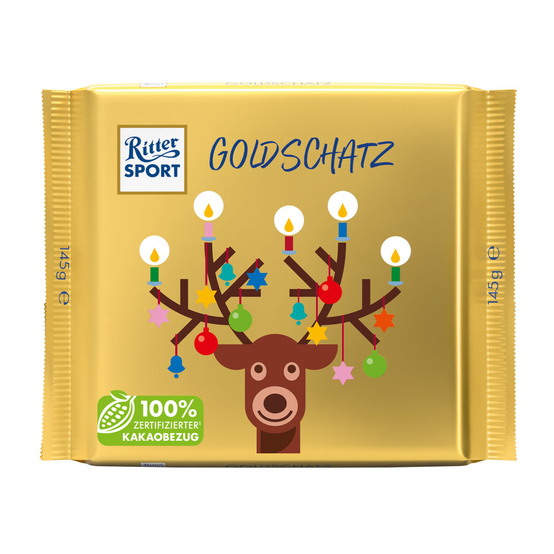 Goldene Ritter Sport-Schokolade mit Rentier- und Christbaumschmuck auf goldenem Hintergrund.