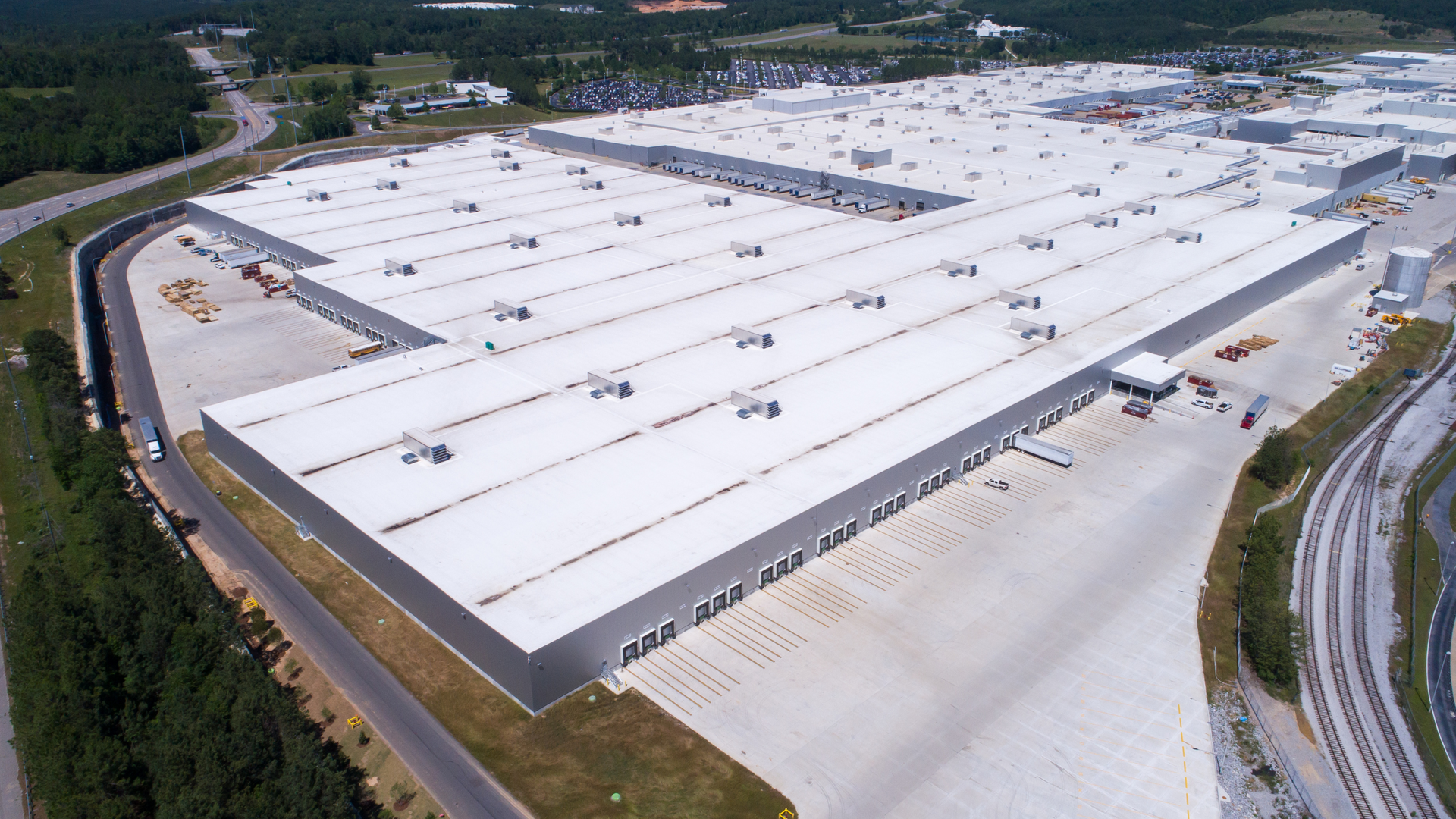An aerial view of a large warehouse with a white roof. Done by a roofing company in layton utah