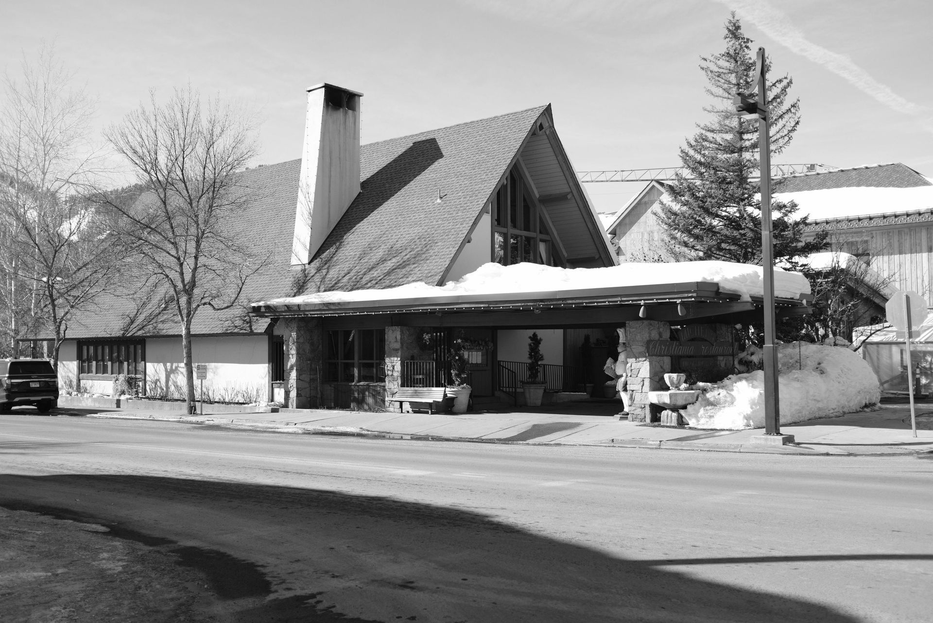 A black and white photo of a house in utah with snow on the roof