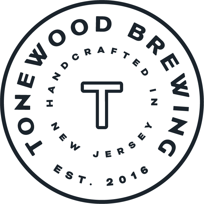 Logo for Tonewood Brewing: white circle with black text. Text includes