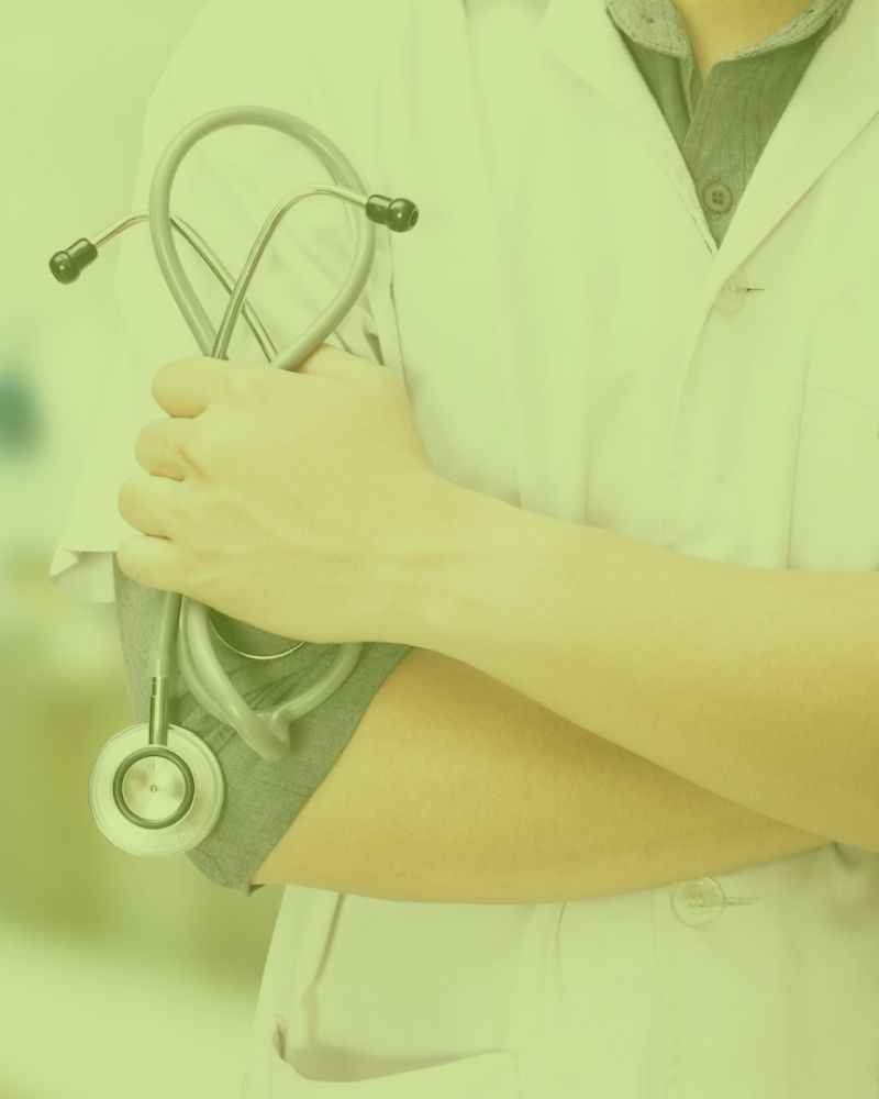 A doctor is holding a stethoscope in his hands.