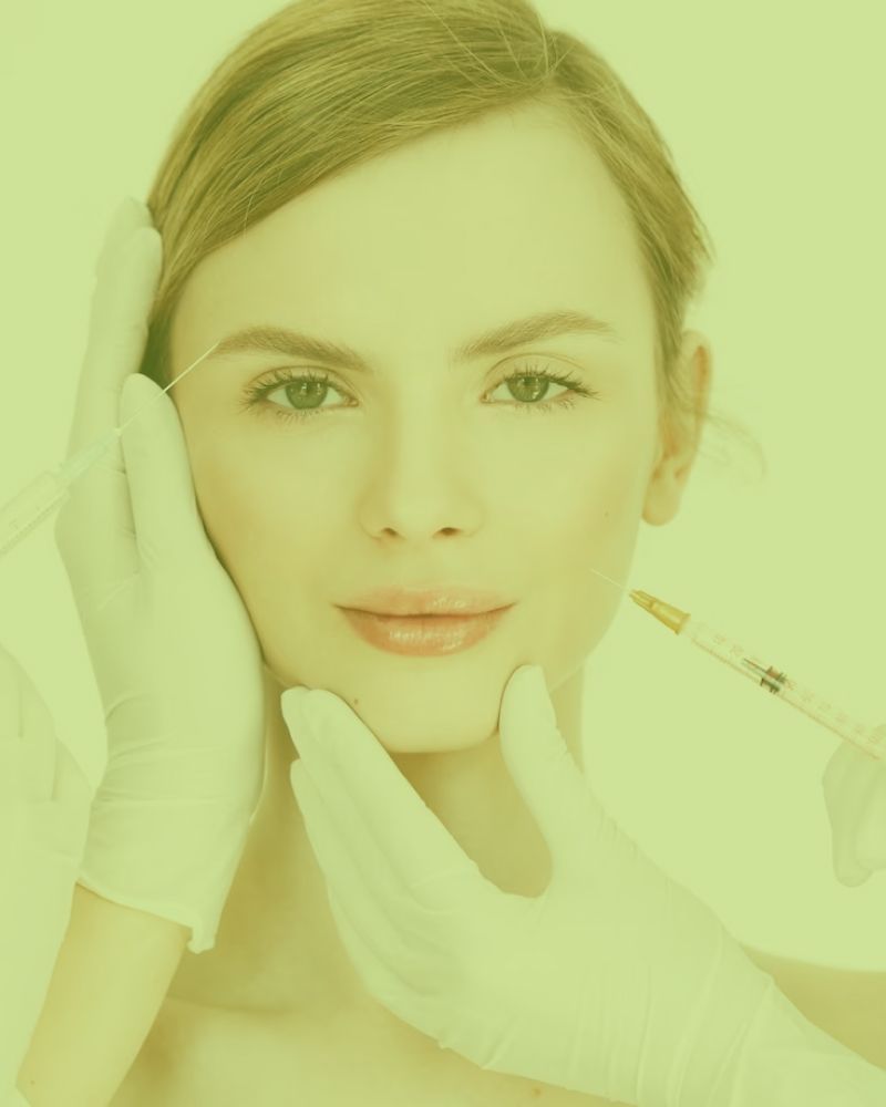 A woman is getting a botox injection in her face.