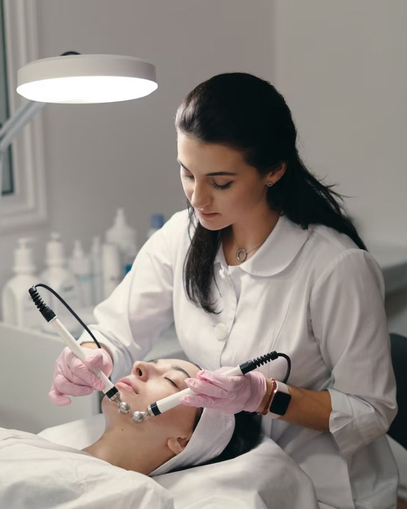 A woman is getting a facial treatment at a beauty salon.
