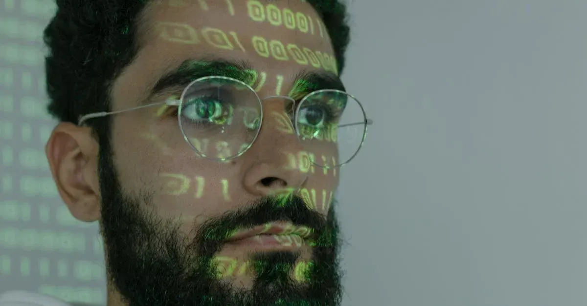 A man with a beard and glasses has binary code projected on his face.