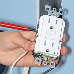 white electrical outlet being wired and installed