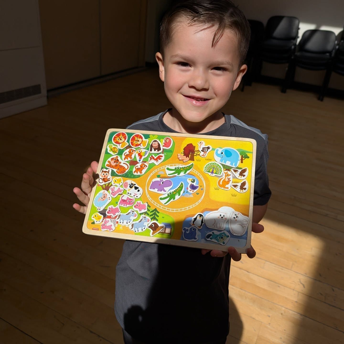 Young boy showing his zoo design activity 